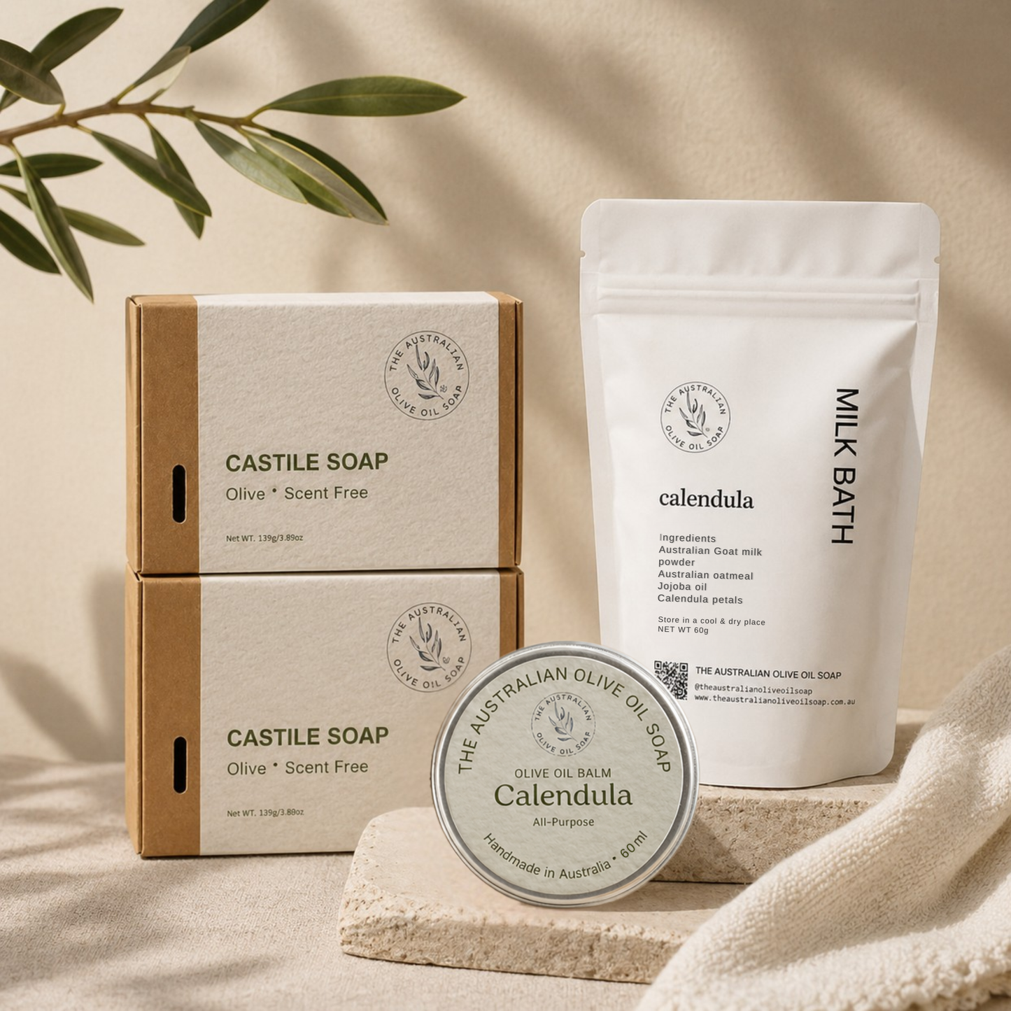 Collection of natural skincare products including soap, balm, and milk bath on a neutral background.