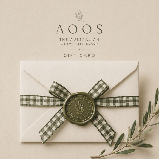 Gift card with a decorative bow and olive oil soap branding on a beige background